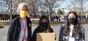James E Moss Teacher With Two Students Getting Chromebook 1 E1614201015301