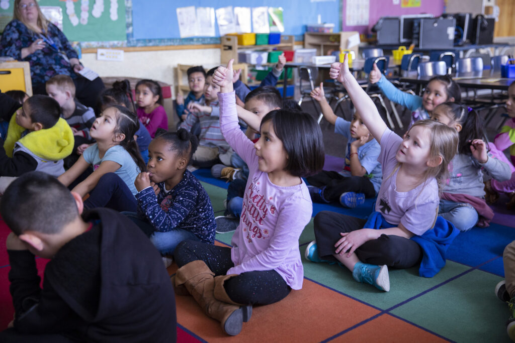 Kids Raising Hands Classroom
