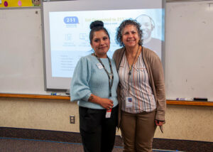 Flor posing and smiling with school staff