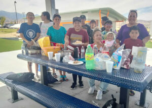 Parents pose at the summer party for Cafe con Flor